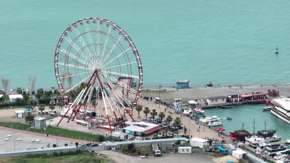 Aerial shot of Ferris wheel, alphabetic tower, skyscrapers and embankment of beautiful Batumi City