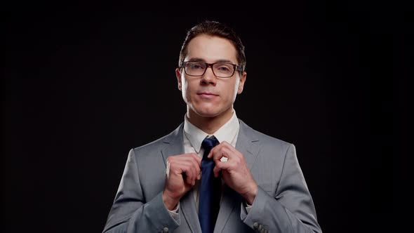 Studio portrait of successful and smart businessman in suit and tie.