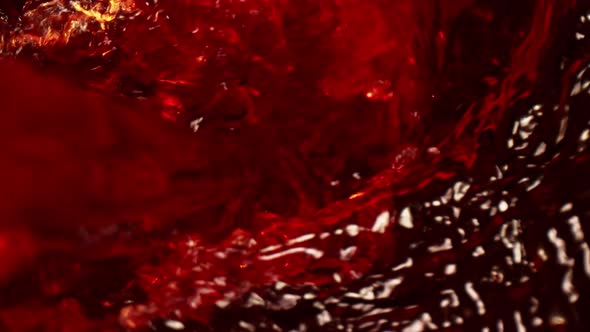 Super Slow Motion Macro Shot of Pouring Red Wine Into Whirl at 1000 Fps