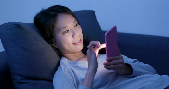 Woman working on cellphone at night