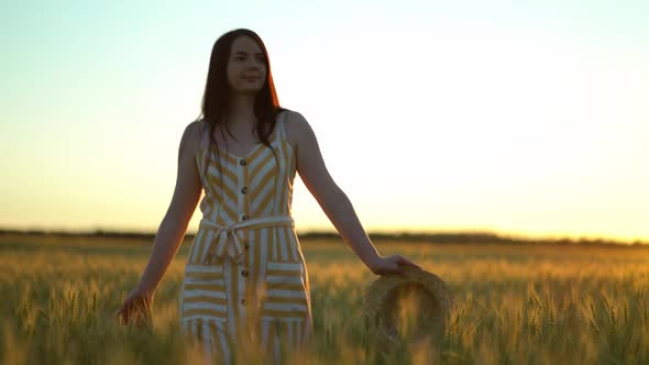 Woman Walking in a Field with Open Arms