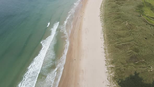 Sea Waves Running To The White Sand Shore Of Whiterocks Beach In Portrush, Northern Ireland On A Sum