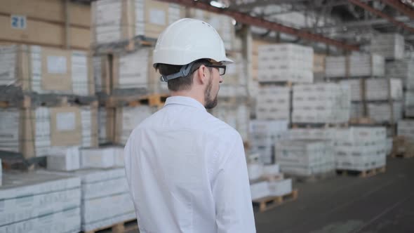 Employee Male Warehouse Worker Engineer Man in Hard Hat Working at Construction Site Warehouse