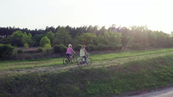 Lifestyle Erial View Two Girls Riding Bicycles in Nature