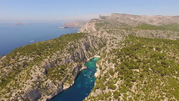 Aerial travel drone view of clear green water, cliffs of Cassis, Mediterranean Sea, Southern France.