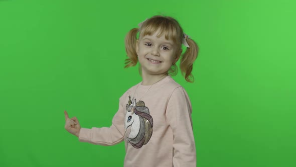 Girl in Unicorn Sweatshirt Emotionally Points at Something with Her Hands