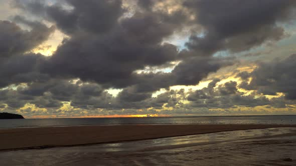 Black Clouds In Yellow Sunset Above The Sea.