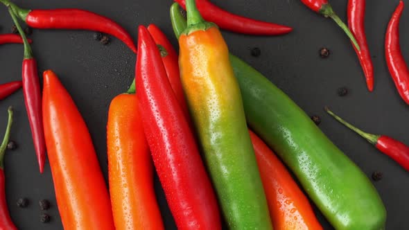 Top View of Fresh Red and Green Hot Pepper with Water Drops Rotate on Tray