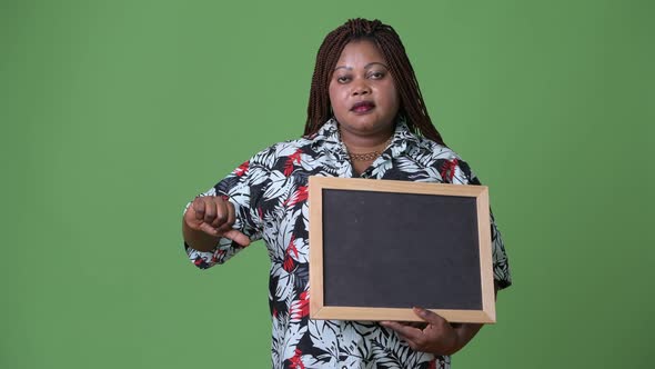 Overweight Beautiful African Woman Against Green Background