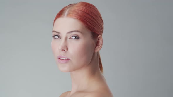 Studio portrait of young, beautiful and natural redhead woman. Beauty concept.