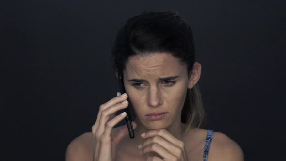 Woman receiving sad news on cell phone