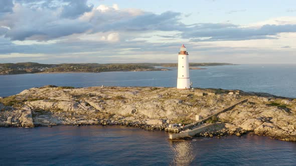 Coastal Lighthouse On The Island of Lille Torungen In Arendal, Agder County, Norway - aerial drone s
