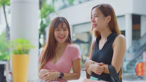 Asian young women shopping outdoor in department store during sale season at end of the year.