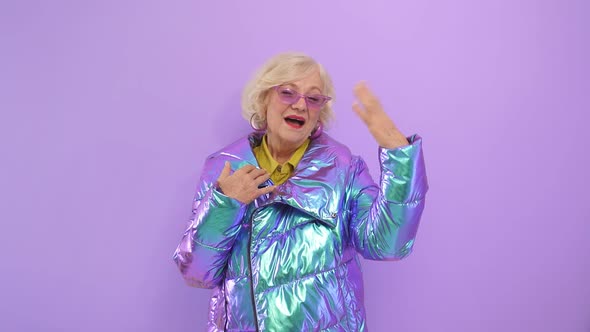 Old Lady Happy with Herself Posing Smiling for the Camera on an Isolated Background in the Studio