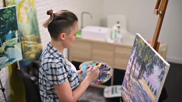 girl artist who paints a picture in his creative studio