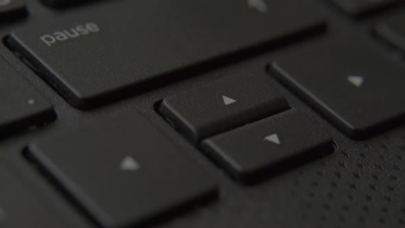 The Finger Presses the Down Button on the Keyboard