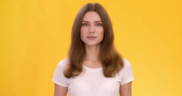 Studio Portrait Beautiful Calm Lady White Tshirt Looking Camera Yellow Background