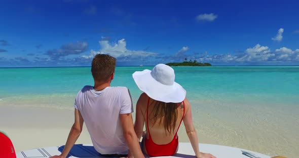 Beautiful boy and girl married on vacation enjoy life on beach on white sand background