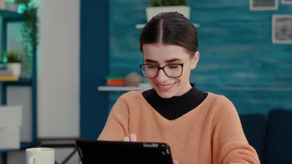 Smiling Woman Using Digital Gadget to Take Lecture Notes