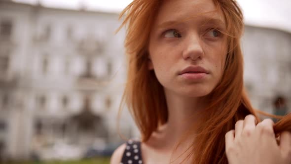 Teenage Cute Caucasian Ginger Girl Looking at Camera Then Away and Down