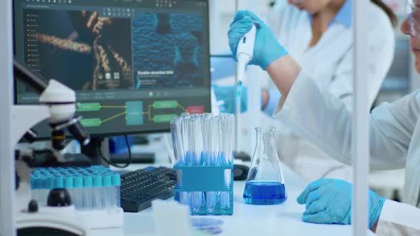 Close Up of Researcher Testing Liquid Sample Using Micropipette