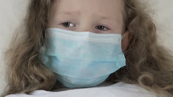 Seriously Sick Female Kid in Medical Mask Looking