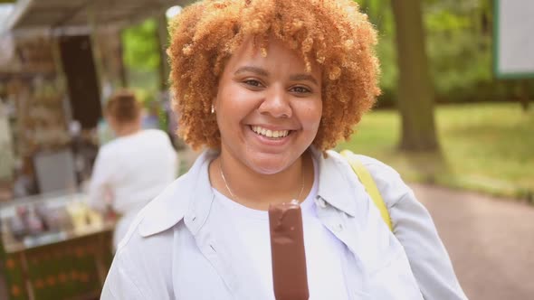 Lifestyle Portrait of Smiling Young Naturally Beautiful Plus Size African American Woman with Afro