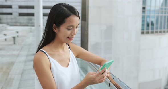 Woman use of smart phone in city