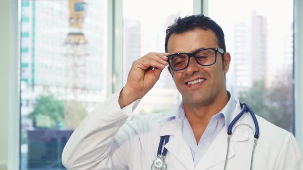 Happy Doctor Takes Off His Glasses and Smiles at the Camera