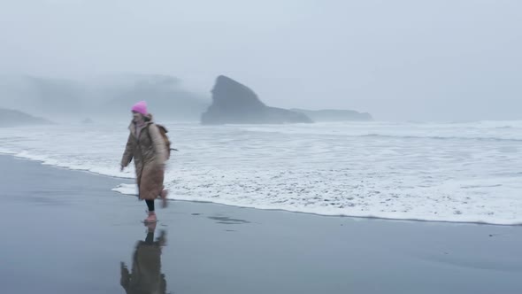 Aerial Shot Beautiful Laughing Woman Running From Ocean Waves USA Winter