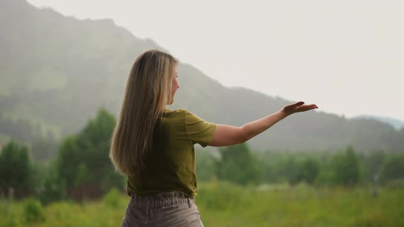 Smiling Lady with Long Hair Has Fun at Warm Summer Rain