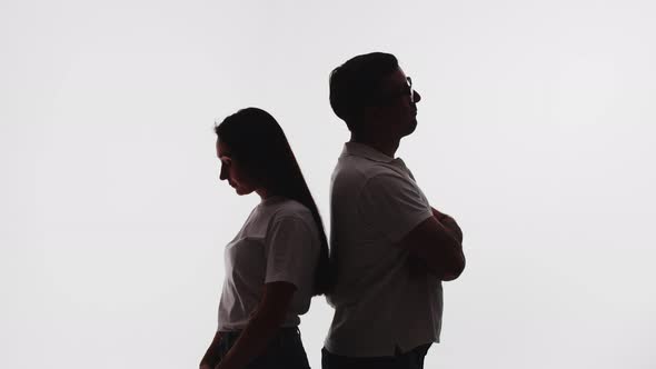 Silhouette of Man and Woman Standing with Their Backs to Each Other Offended After Quarrel White