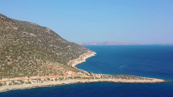 aerial drone of a coastal road along the dark blue Mediterranean Sea in Kas Turkey on a sunny summer