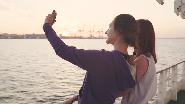 Two Beautiful Women Making Selfie Photo While Enjoying Vacation on a Boat