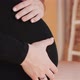 Pregnant Woman in Black Dress Holds Hands on Belly. - VideoHive Item for Sale