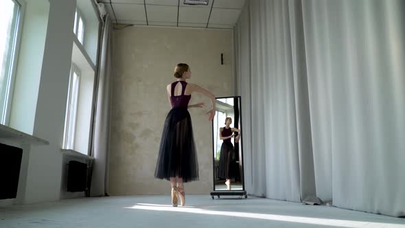Young Female Dancer in Does Ballet Exercises on the Tiptoes in Beige Pointe Shoes, Rehearsal 