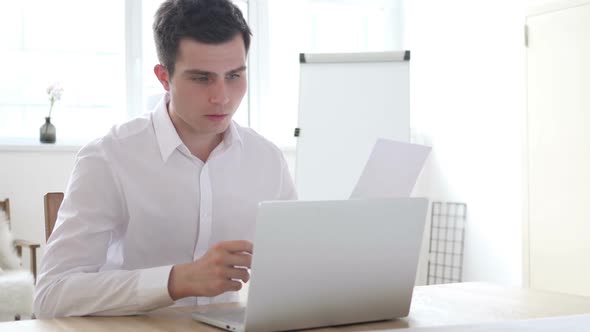 Angry Businessman Upset After Reading Documents Paperwork