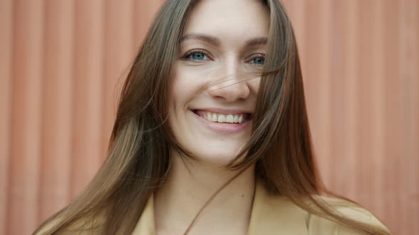 Closeup Portrait of Attractive Girl Smiling Looking at Camera Outdoors on Windy Summer Day