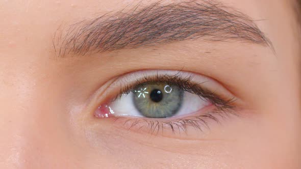 Extreme Close Up of Woman Opening Beautiful Eye with Grey Iris