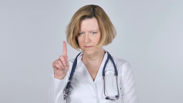 Portrait of Old Doctor Waving Finger To Refuse