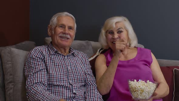 Overjoyed Old Mature Couple Football Fans Watching Sport Tv Game Support Cheer Winning Soccer Team