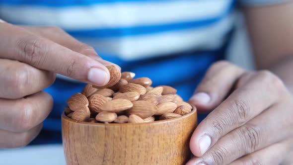 Almond Nuts on Man's Hand Close Up