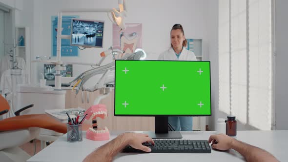 POV of Man Using Keyboard and Computer with Green Screen