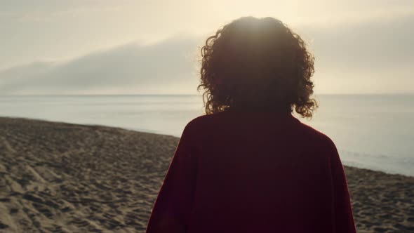 Elegant Woman Walking on Ocean Beach