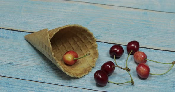 Berry Ice Cream. Berries of Cherry in a Waffle on a Blue Wooden Background