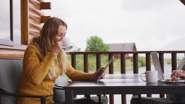 Caucasian couple spending time at home together, sitting outside the cabin