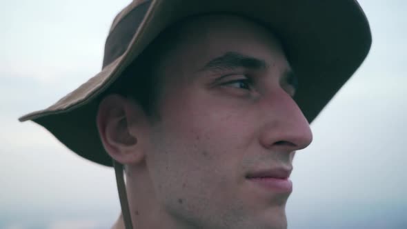 Shooting with a male model in his twenties. He wears a bucket hat and stands on the City Wall of Nan