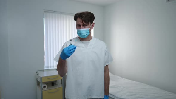 Medium Shot Serious Doctor in Face Mask and Uniform with Coronavirus Vaccine Stretching Hand Shaking