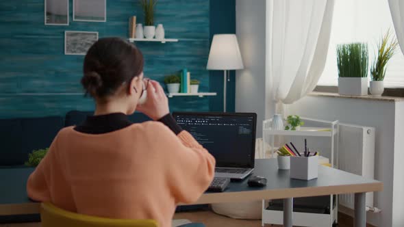 Young Adult Working on Binary Code Programming at Desk