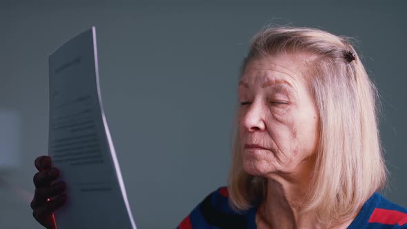 Disappointed Old Woman Reading Document